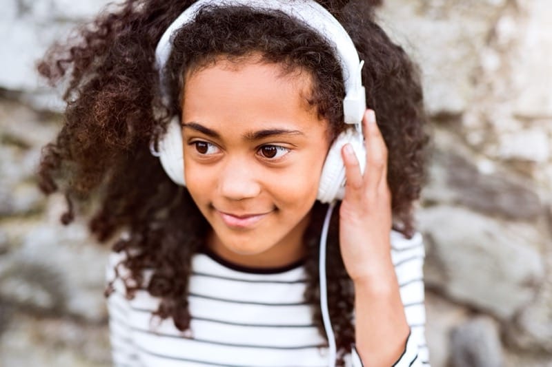 young child using child safe headphones