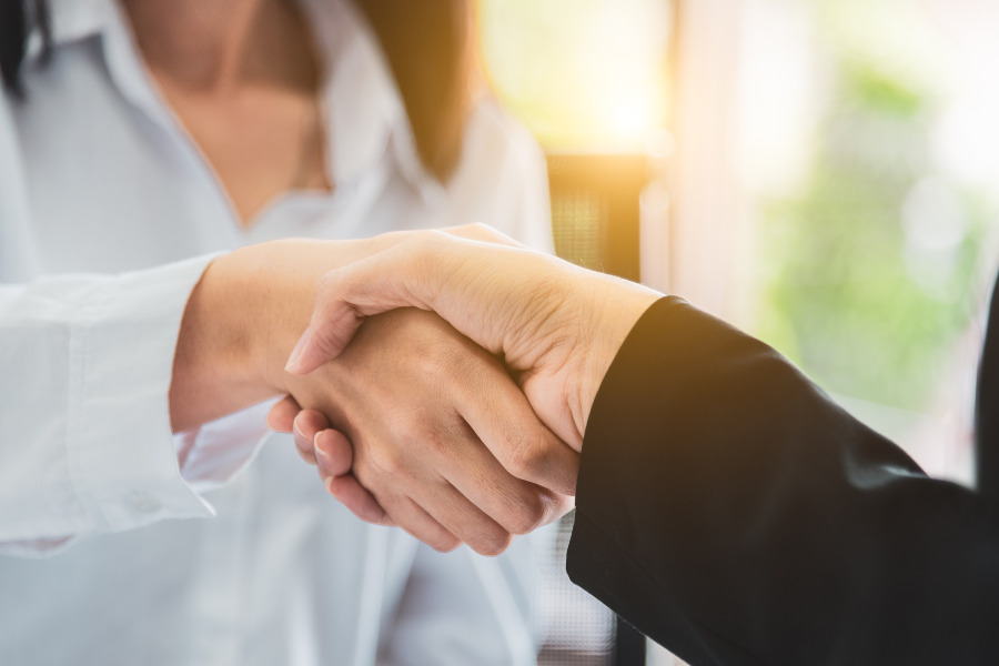 Pharmacist shaking hands with business partner